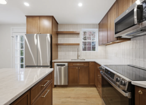 Kitchen remodeling in Arlington, VA, featuring wood cabinets, stainless steel appliances, and a large island