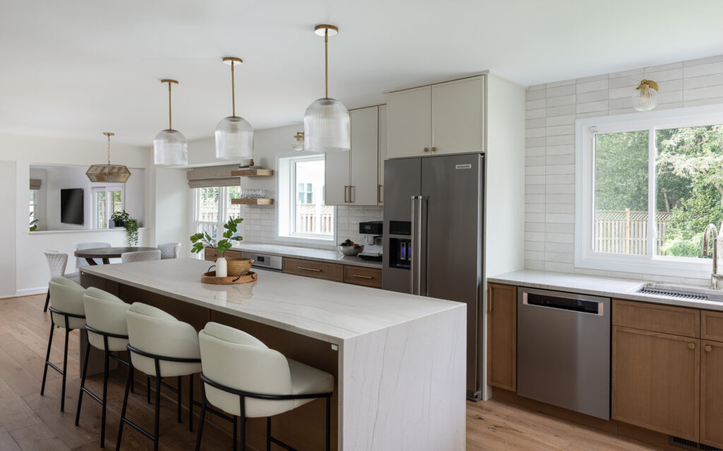 Bright renovated kitchen with an island, bar seating, and custom cabinets