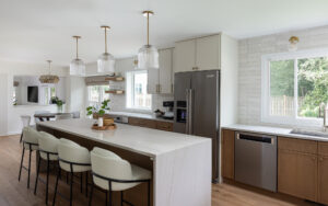 Bright renovated kitchen with an island, bar seating, and custom cabinets